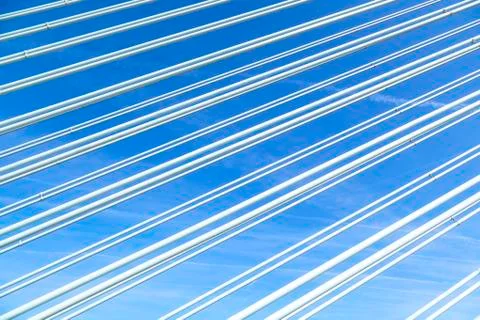 Pattern of steel wires of a bridge under blue sky Stock Photos