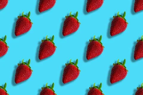 Pattern of strawberries isolated on blue background. Seamless pattern Stock Photos