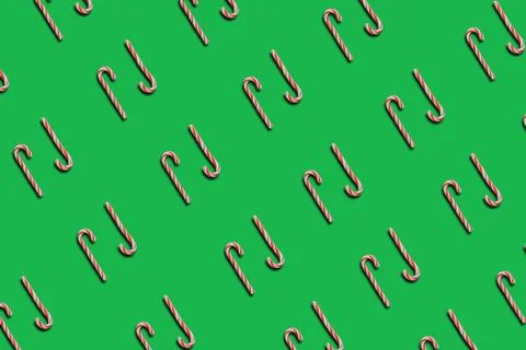 Pattern striped candy sticks on green background, lollipop, top view, flat la Stock Photos
