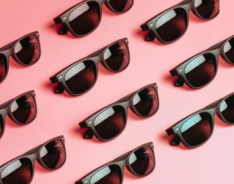 Pattern of sunglasses over a pastel pink background with copy space minimal.. Stock Photos