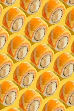 A pattern of sushi rolls on a yellow background Stock Photos