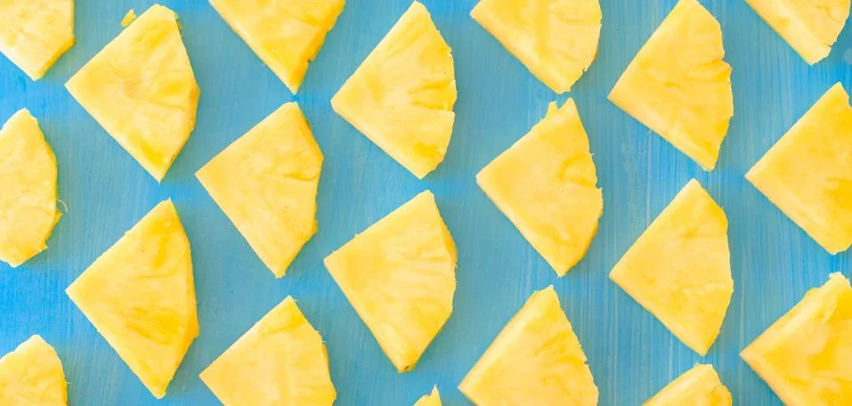 Pattern of Sweet pineapple on blue background top view, flat lay Stock Photos