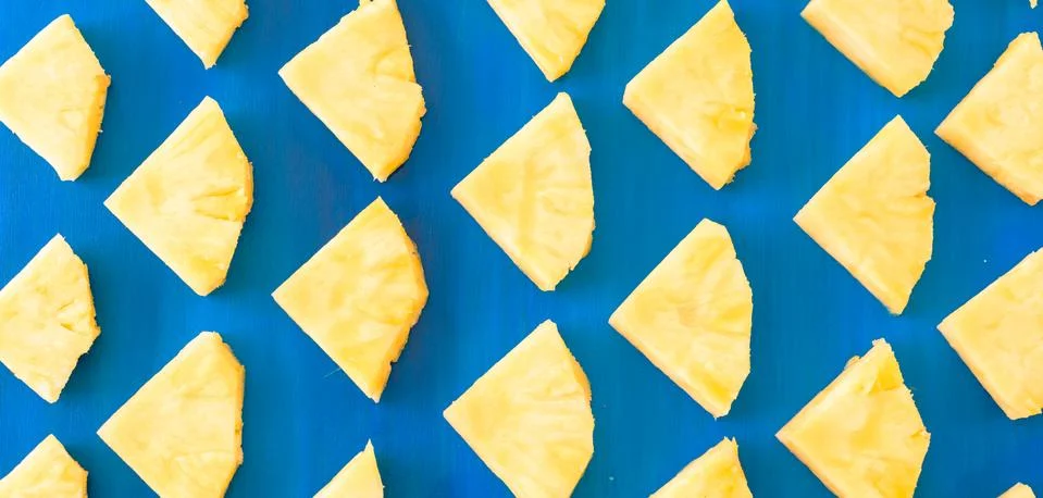 Pattern of Sweet pineapple on blue background top view, flat lay Stock Photos