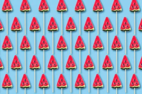 Pattern of sweets in shape of watermelow on blue background. Minimal flat lay Stock Photos