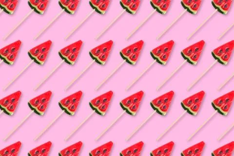 Pattern of sweets in shape of watermelow on pink background. Minimal flat lay Stock Photos