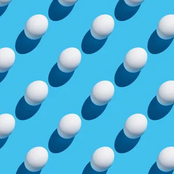 The pattern of their white eggs with a hard shadow on a blue background. Stock-Fotos