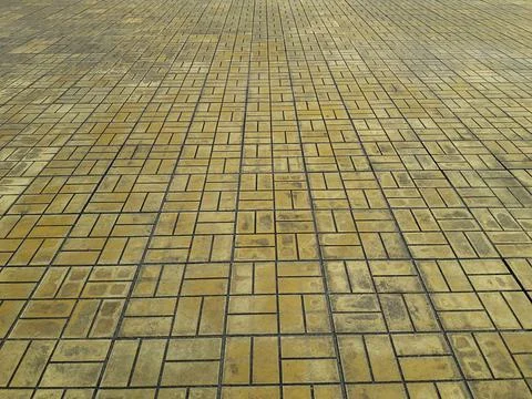 The pattern of tiles on the floor yellow cobblestone road Stock Photos
