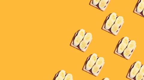 Pattern of toasted bread with banana and chocolate on yellow background. Stock Photos
