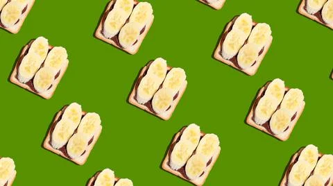 Pattern of toasted bread with banana and chocolate on green background. Stock Photos