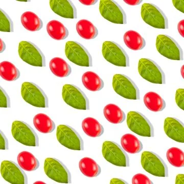Pattern with tomato cherry and basil leaves on a white background 库存照片
