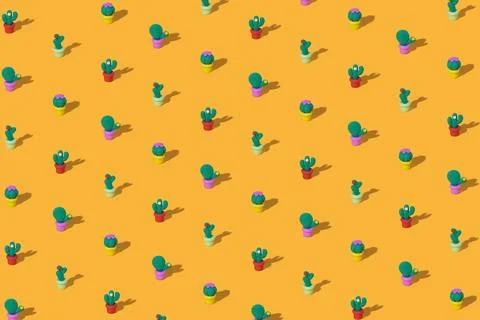 Pattern of toy green cacti on a bright yellow background Stock Photos