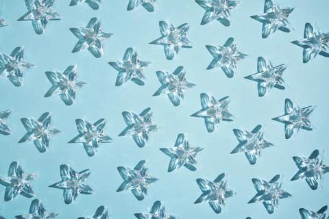 Pattern of transparent stars on a blue background. Stock Photos