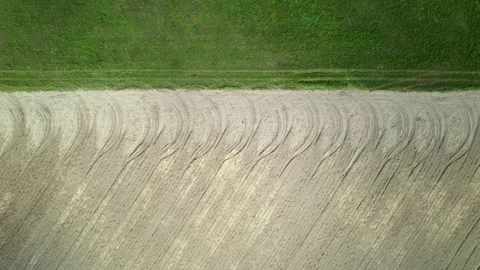 Pattern of tread marks from tractor wheels on farmland. 動画素材 164347262
