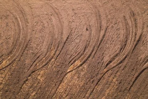 Pattern from tread wheel tracks on a plowed field. Stock Photos