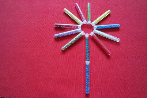 Pattern of tubes with small beads flower red background Stock Photos