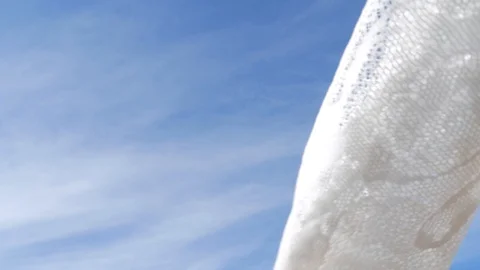 Pattern tulle in the wind on the background of blue sky 12 Stock Footage 129463319