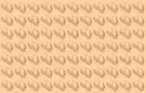 Pattern of unpeeled peanuts on beige background Stock Photos