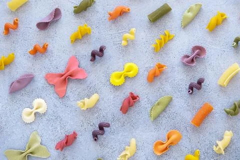 Pattern. Variety of types and shapes of Italian pasta on concrete background. Stock Photos