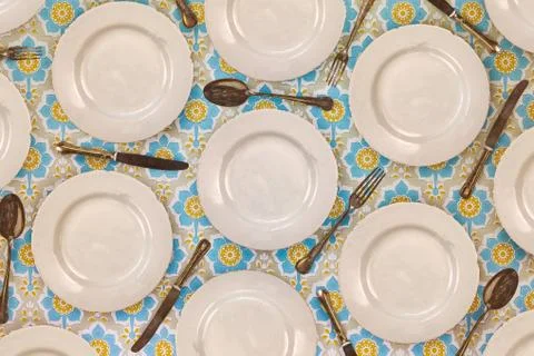 Pattern of vintage dinner plates, knives, forks and spoons Stock Photos
