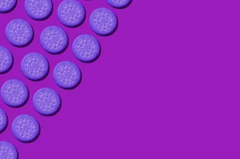 Pattern from violet biscuits on an lilac background. Abstract background. Pla Stock Photos