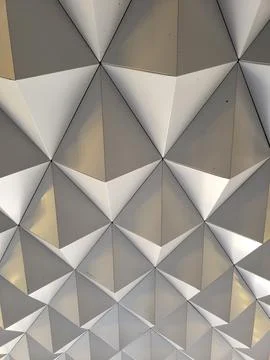 The pattern on the wall features interlocking grey triangles, some with a r.. Stock Illustration