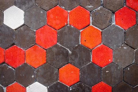 Pattern on the wall with red, brown and white octagon shape tiles. Stock Photos