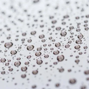 Pattern of water drops in a shining metallic surface with sky reflections,Wat Stock Photos