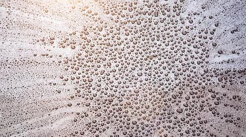 Pattern of water drops in a shining metallic surface with sky reflections,Wat 스톡 사진