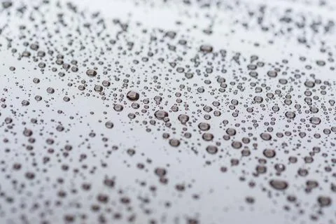 Pattern of water drops in a shining metallic surface with sky reflections,Wat Stock Photos