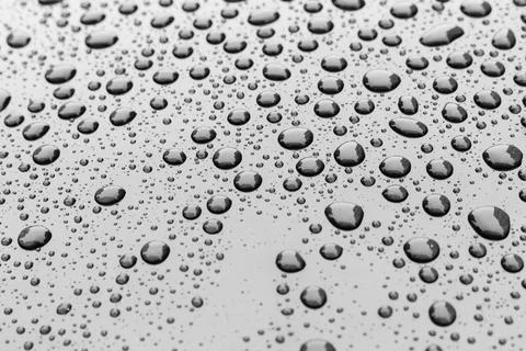 Pattern of water drops in a shining metallic surface with sky reflections,Wat Stock Photos
