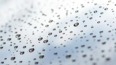 Pattern of water drops in a shining metallic surface with sky reflections,Wat Stock Photos