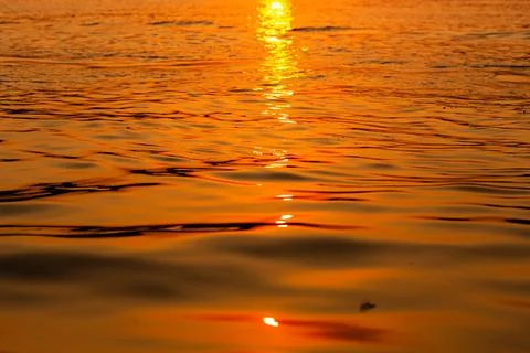 A pattern of waves colored with sunset light Foto stock