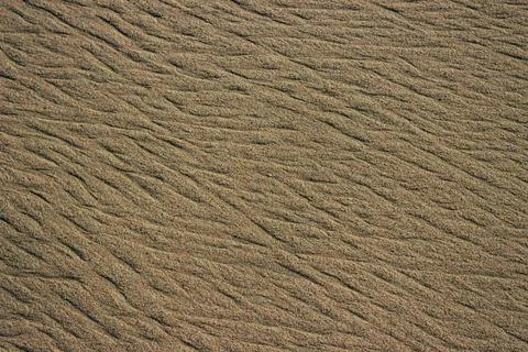 Pattern of waves on sand created by wind and water Stock Photos