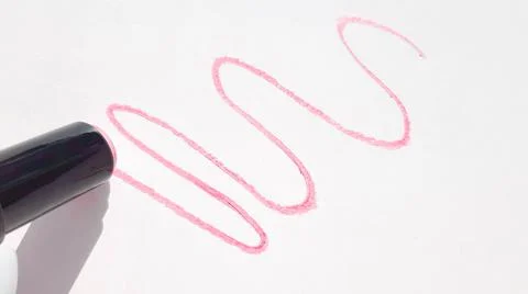 A pattern with wavy lines of red lipstick on a white background, the shadow o Stock Photos