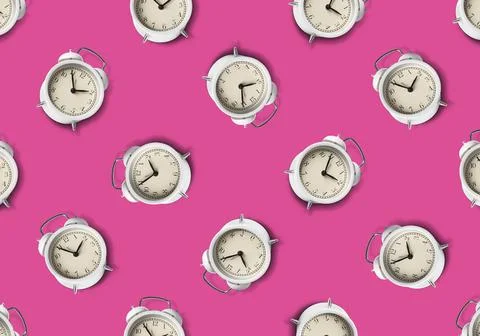 Pattern of white alarm clocks on violet red background Foto stock