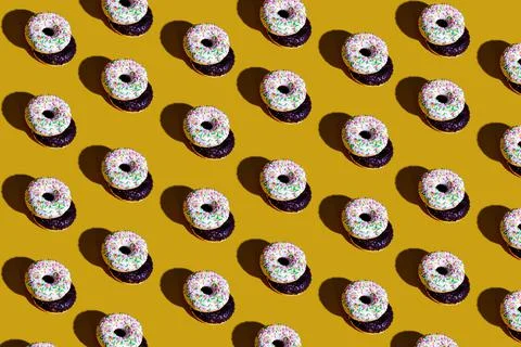 A pattern of white and black doughnuts. food pattern background texture splas Stock Photos