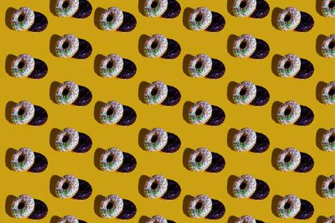 A pattern of white and black doughnuts. food pattern background texture splas Stock Photos