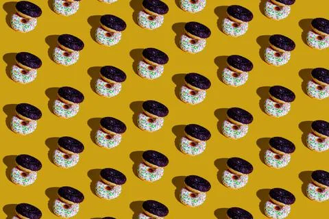 A pattern of white and black doughnuts. food pattern background texture splas Stock Photos