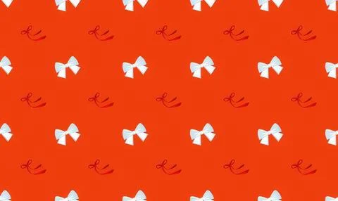Pattern of white bows and red ribbons on orange background Stock Illustration