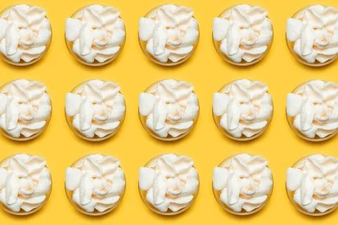 Pattern of white chips in round bowls on orange background. Stock Photos
