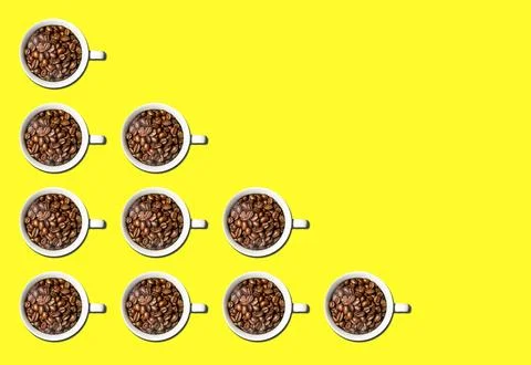 Pattern of white coffee cups full of coffee beans isolated over bright colorful Stock Photos