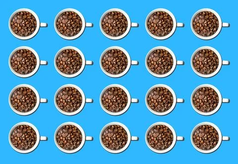 Pattern of white coffee cups full of coffee beans isolated over bright colorful Stock Photos