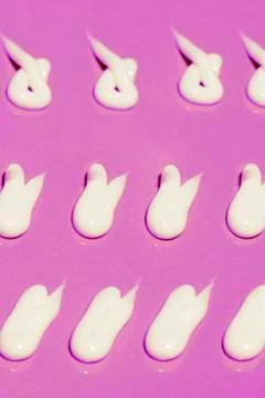 The pattern of white cream drops of different shapes Stock Photos