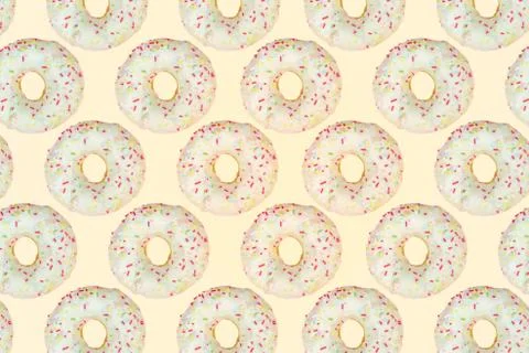 Pattern of a white donuts on a yellow background. Flat lay Stock Photos