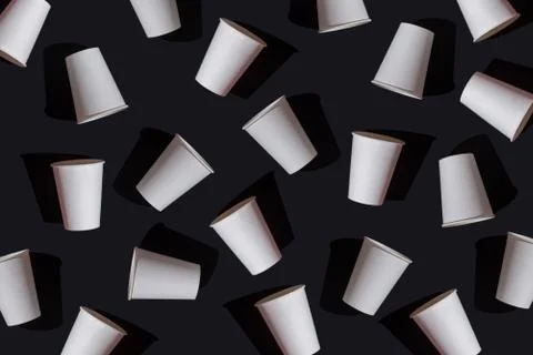 Pattern white paper disposable cups on black background, mock up, top view Stock Photos