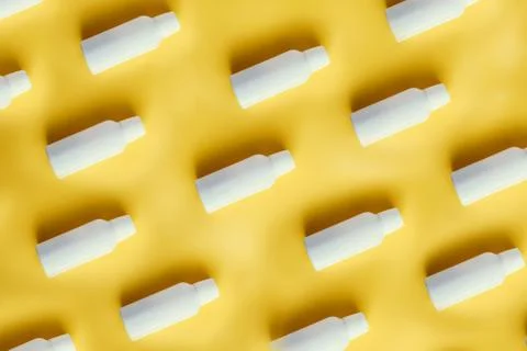 Pattern of white plastic bottles of containers for dairy products Stock Photos