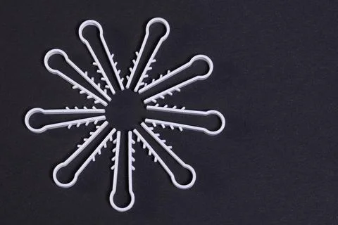 A pattern of white plastic elements for attaching the wire to the wall and ce Stock Photos