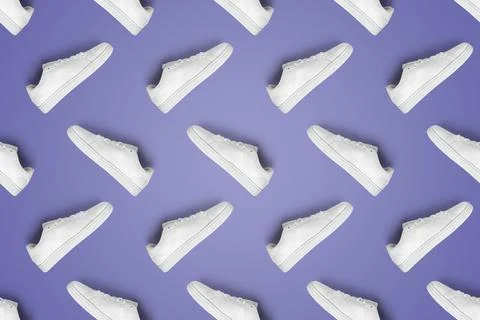Pattern of white sneakers on Very Peri background. Stock Photos