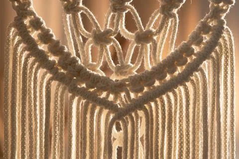 Pattern of whites macrame threads on a stick for decoration or home decor Foto stock
