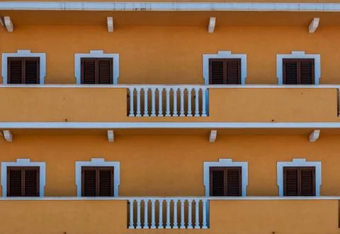 Pattern with windows on yellow and white building Stock Photos